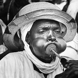 A tribesman from Bida in Northern Nigeria blowing his trumpet as part of the reception