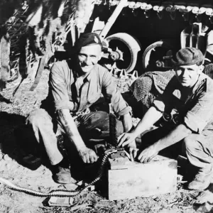 Trooper F. Willis and Lance Corporal T. A. Jones load ammunition into their tanks machine Trooper F. Willis and Lance Corporal T. A. Jones load ammunition into their tanks machine