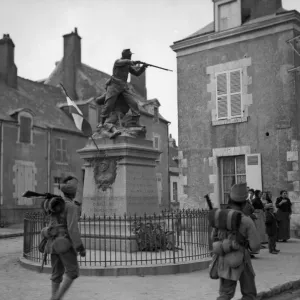 Troops from the 3rd Indian Division moving up to the front admire the statue of a