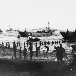 Troops unloading at Anzio. Men up to their waists in water, unloading stores Troops unloading at Anzio. Men up to their waists in water, unloading stores