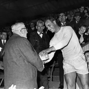 trophy as player manager of Hereford United at the second leg of the cup final at Ninian