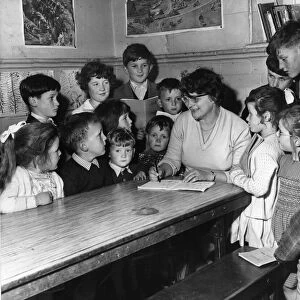 Tryweryn Valley - Mrs Martha Roberts marks the books of her young pupils in the one room