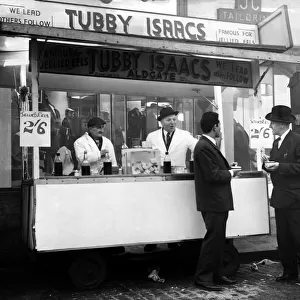 Tubby Isaacs behind the counter of one of his mobile stalls selling jellied eels while