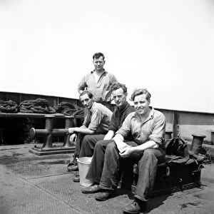 Tug boat crew seen aboard ship. June 1952 C3046