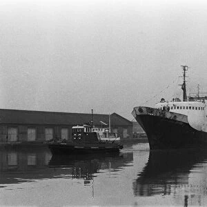 The tug Castle guides the stern trawler Boston Lincoln into a misty St Andrews Dock