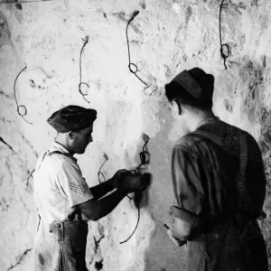 The Tunnellers'of the Royal Engineers lighting explosive fuses for blasting