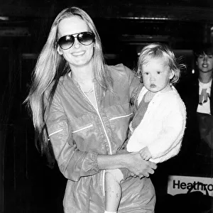 Twiggy actress and model with 21 month old daughter at Heathrow airport. July 1980