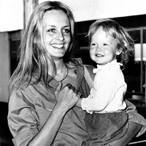 Twiggy Model and Actress holding baby