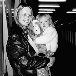 Twiggy model holding her daughter Carly in her arms
