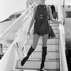 Twiggy, (real name Leslie Hornby) English model, seen in a Hippie gear outfit leaving