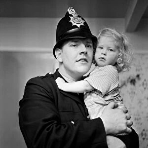 Two-year-old Deborah Almond, and PC Brian Corner, who rescued the toddler from a river
