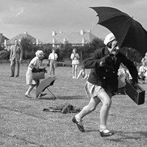 The umbrella race during a schools sports day in Kingston Upon Thames. Circa 1936