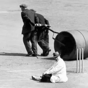 Umpire taking a rest whilst groundsmen roll the wicket. 15th July 1952 Umpire taking a rest whilst groundsmen roll the wicket. 15th July 1952