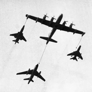 A United States Air Force tanker refuelling fighter planes during a demonstration A United States Air Force tanker refuelling fighter planes during a demonstration
