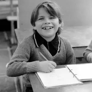 Print of a 9-year-old boy studying in a caravan classroom Print of a 9-year-old boy studying in a caravan classroom