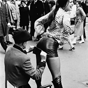 Unusual Picture of Czech model Dana Mala having her hot pants polished by a bootblack