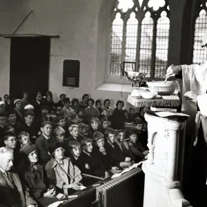 Unusual - A vicar prepares his christmas pudding at a service in church