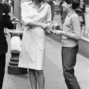 Ursula Andress, actriz suiza, firma autógrafo para admirador joven.