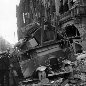 A van being loaded with furniture moving items from a bombed building is covered by A van being loaded with furniture moving items from a bombed building is covered by