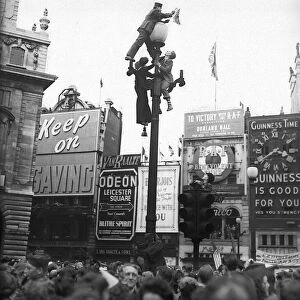 VE Day celebrations in London at end of WW2 people on a lamp post
