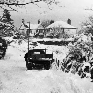 A vehicle making its way through thick snow in rural Llanedeyrn A vehicle making its way through thick snow in rural Llanedeyrn