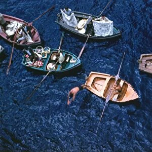 Venders selling their wares from small boats in the harbour at Funchal, Madeira
