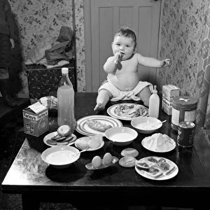 Victor Reay 2 1 / 2 stone 7 month old baby sitting on table with the food that