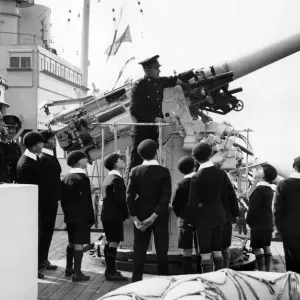 View day of HMS London. Schoolboys watching a demonstration of an aircraft gun View day of HMS London. Schoolboys watching a demonstration of an aircraft gun