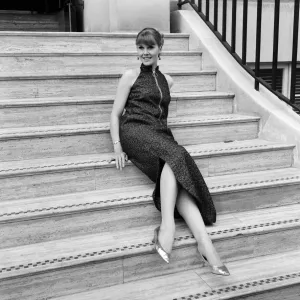 Virginia Bird wearing a full length evening dress in lined brocade with a slit skirt Virginia Bird wearing a full length evening dress in lined brocade with a slit skirt