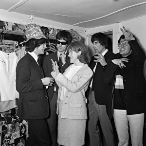 Virginia Campbell meets British rock group The Kinks at a dress shop in Kennington