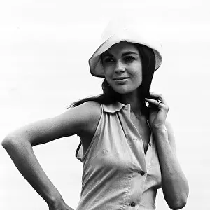 Virginia North modelling beach fashion - a one piece outfit with button detail