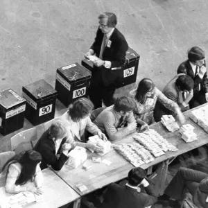 Votes already counted and stacked into neat bundles on one of the counting tables Votes already counted and stacked into neat bundles on one of the counting tables