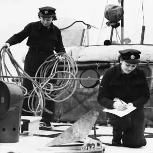 W. A. A. F airwomen on an R. A. F. station checking the equipment on a new boat W. A. A. F airwomen on an R. A. F. station checking the equipment on a new boat