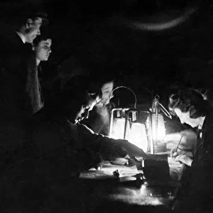 A W. V. S. incident enquiry. Working by the light of Hurricane lamps tense people still