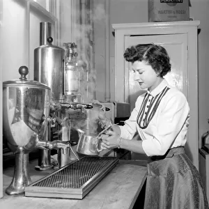 Waitress / woman seen here preparing pots of tea in a cafe. 1957 A17b-002
