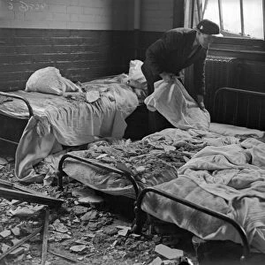 A warden searches the damaged wards of Erdington House hospital following a raid