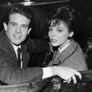 Warren Beatty and fiancee Joan Collins sitting in theatre - February 1961