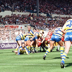 Warrington desperately clear their lines from deep within their own half during the Rugby