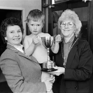 Water baby William receives his trophy from the Mayoress (left) and Deputy Mayoress