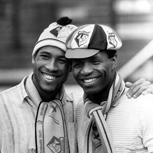 Watford and England duo John Barnes and Luther Blissett pose wearing club hats