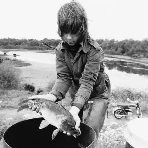 Weather drought boy rescues a carp at Coleshill Pool Warwickshire dbase msi Weather drought boy rescues a carp at Coleshill Pool Warwickshire dbase msi