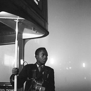 Weather London Smog December 1962. A London Transport bus conductor looks out from