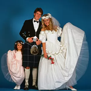 Wedding dress fashion, February 1987 Model wearing wedding dress with groom wearing