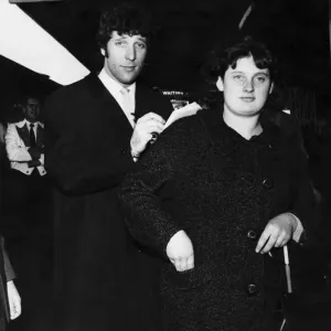 Welsh singing star Tom Jones signs an autograph for a fan at Cardiff Central Railway