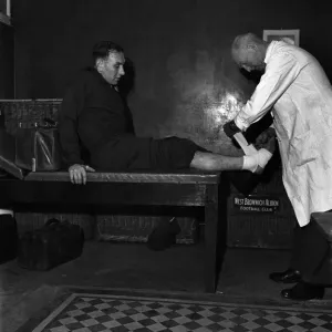 West Bromwich Albion F. C. Trainer Fred Read bandages ankle of footballer Billy Elliot West Bromwich Albion F. C. Trainer Fred Read bandages ankle of footballer Billy Elliot