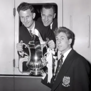 West Bromwich Albion Players on the the train with the FA Cup trophy as they leave London