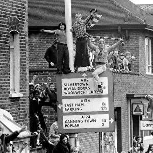 West Ham fans try to get a good view above the crowds during the West Ham victory parade
