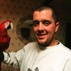 West Ham football player Julian Dicks at home with his pet parrot
