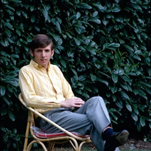 West Ham United footballer Martin Peters relaxes sitting on a deckchair October