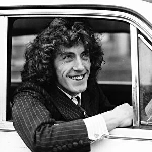 The Who pop group member Roger Daltrey sitting in car